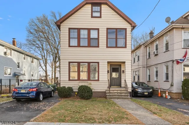 a view of a car park in front of a house