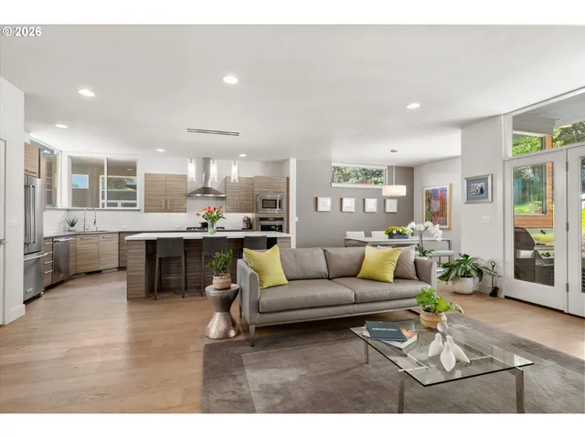 a living room with furniture and kitchen view