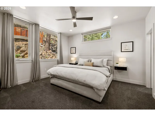 a spacious bedroom with a bed and a window