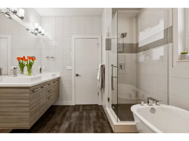 a bathroom with a tub sink and mirror