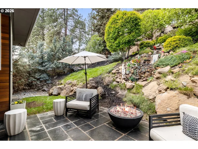 a view of a patio with couches chair and umbrella