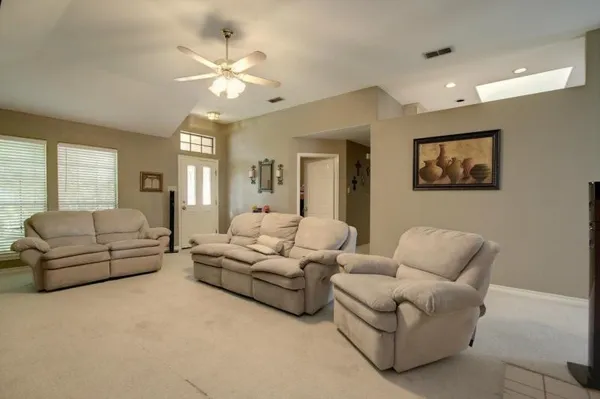 a living room with furniture a large bed and a chandelier