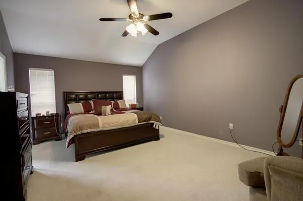 a bedroom with a bed and a chandelier