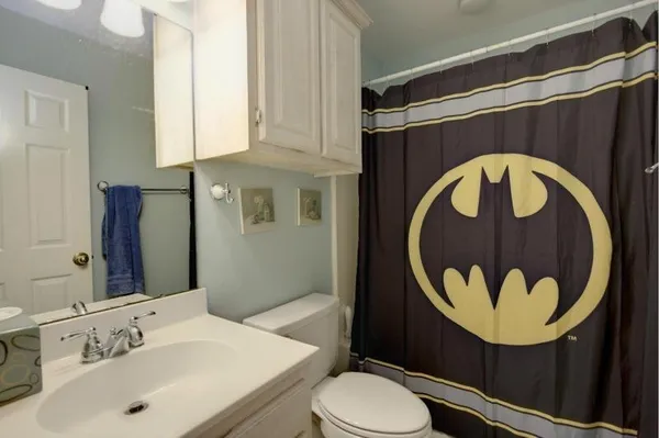 a bathroom with a sink mirror vanity and toilet