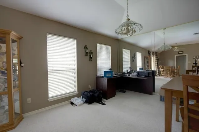 a view of a livingroom with furniture and windows