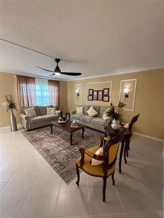 a living room with furniture a rug and a window