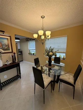 a dining room with furniture and chandelier