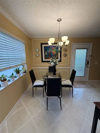 a dining room with furniture a chandelier and a rug