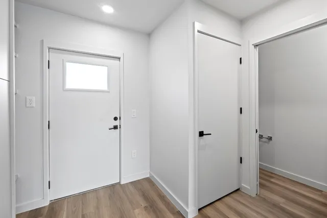 a view of a hallway with wooden floor