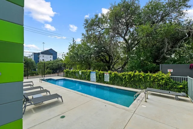 a view of swimming pool with lounge chair and garden view