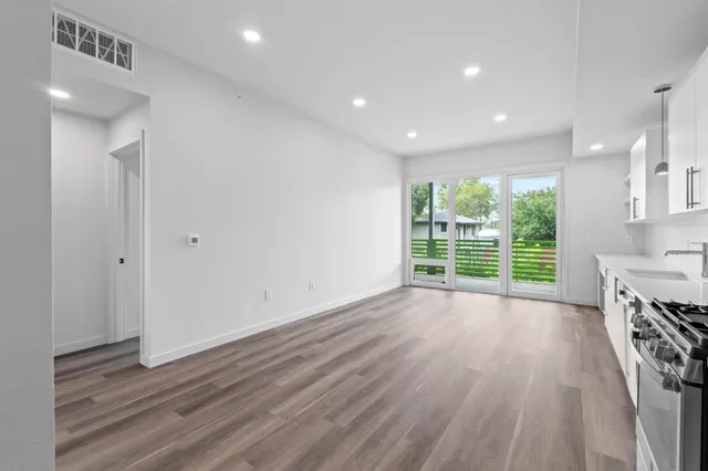 a view of wooden floor and windows in a room
