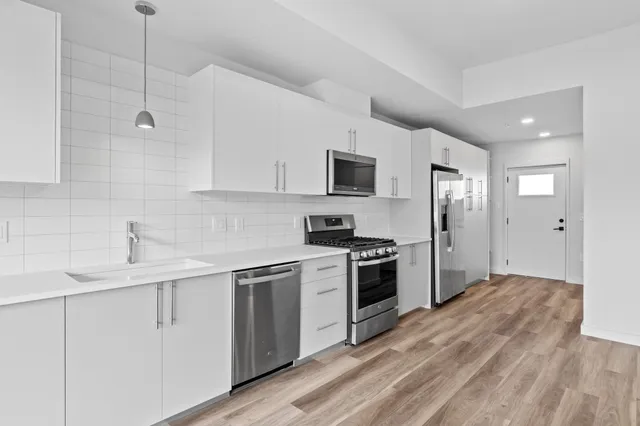 a kitchen with a sink stove and refrigerator