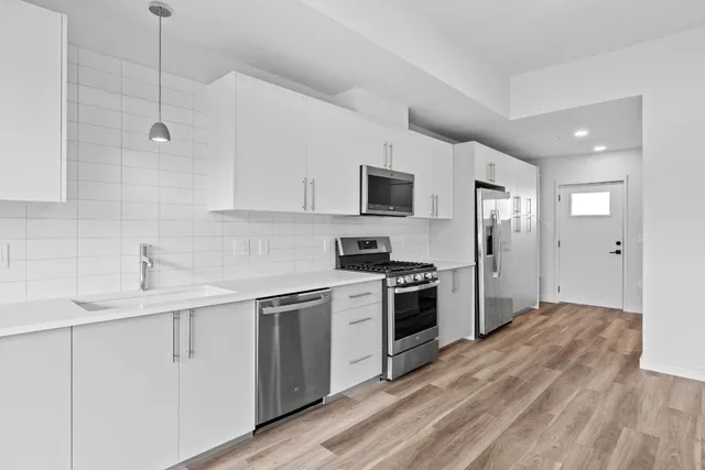 a kitchen with a sink stove and refrigerator