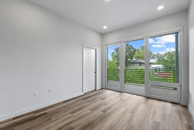 a view of a room with wooden floor