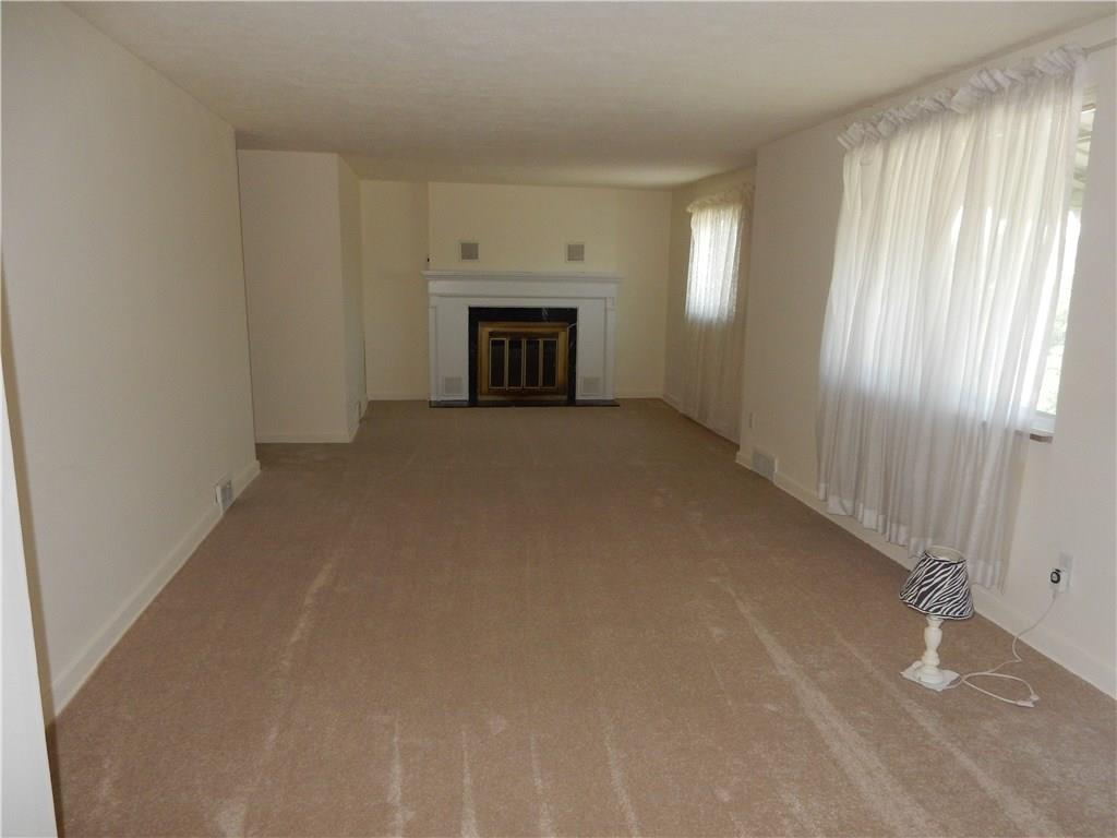 3719 Schuette Road Pittsburgh, PA 15227 - Photo 2 of 24 Look how big this living room is!! 29X12 is huge! Log burning fireplace, front entryway is off to the right, dining room is off to the left top and the kitchen is off to the left bottom. New carpet just installed!