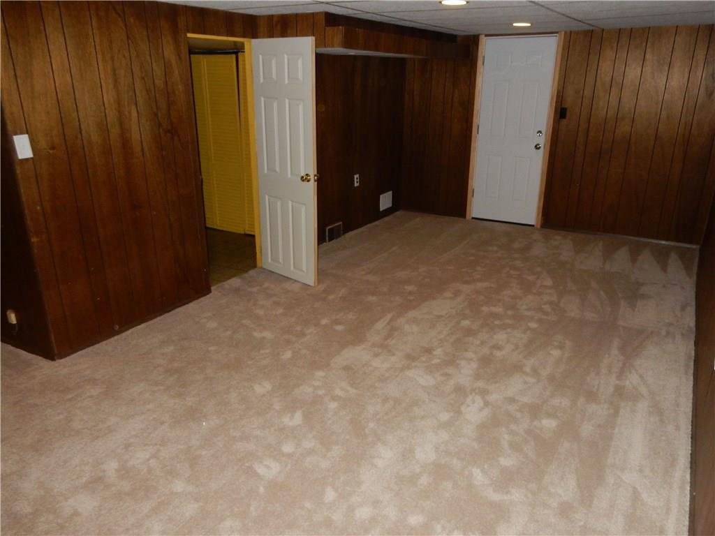 3719 Schuette Road Pittsburgh, PA 15227 - Photo 18 of 24 The game room on the lower level with a full bath off to the left, the garage straight ahead and the laundry room off to the lower left. The storage space in this home is incredible!