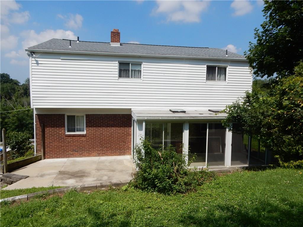 3719 Schuette Road Pittsburgh, PA 15227 - Photo 20 of 24 A view of the back yard, you can see the sun room and a nice patio area