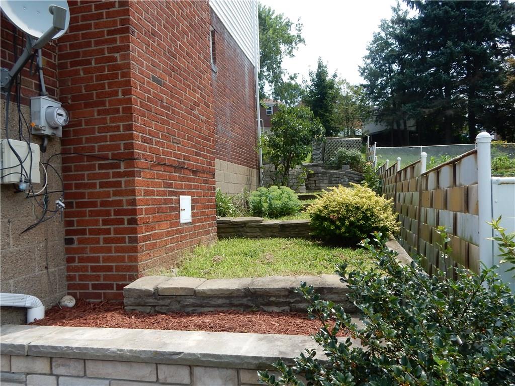 3719 Schuette Road Pittsburgh, PA 15227 - Photo 21 of 24 A side view of the home with tiers of landscaping stone, fantastic area for your garden choice