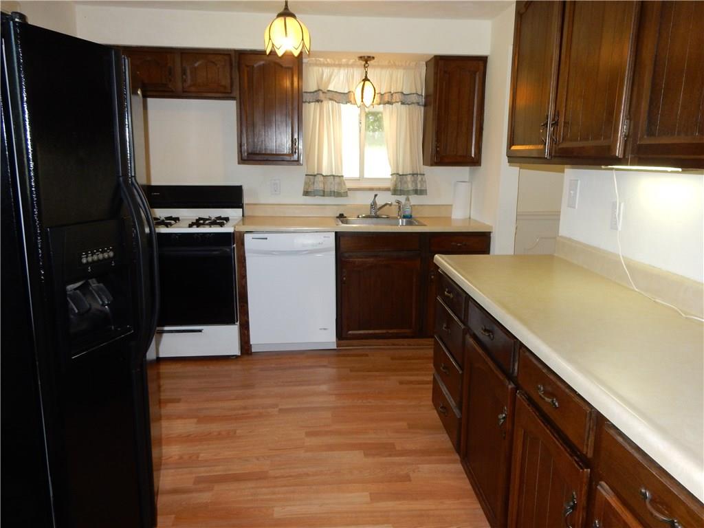 3719 Schuette Road Pittsburgh, PA 15227 - Photo 4 of 24 Here is your large kitchen, plenty of cabinets and counterspace with the entry to outside off to the left and the dining room off to the right