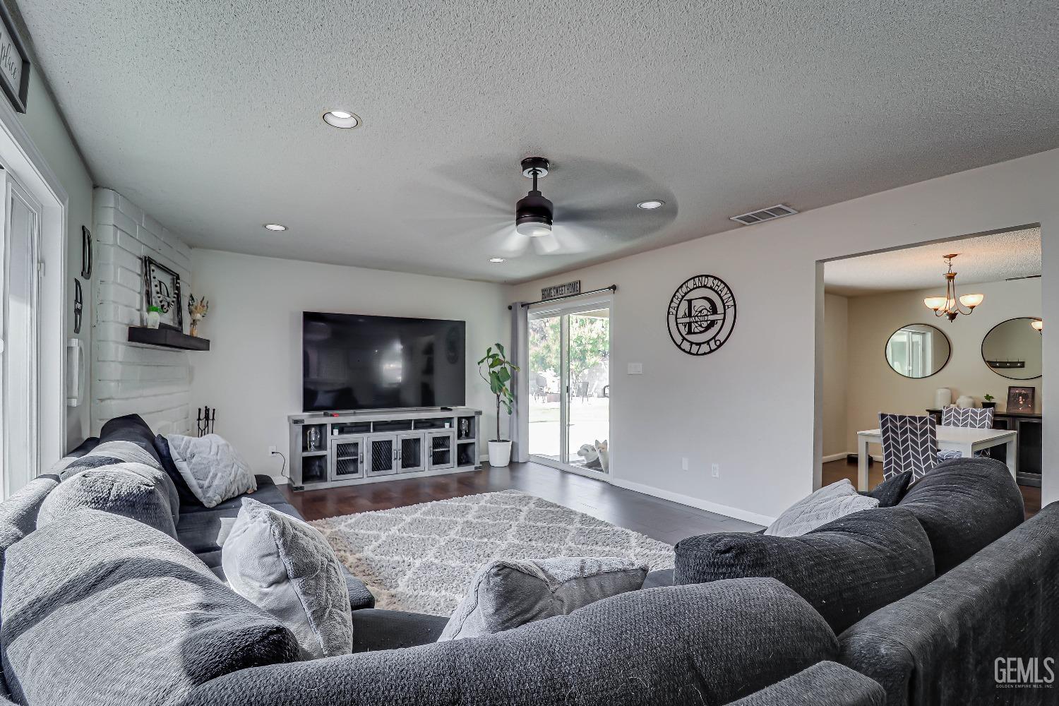 Undisclosed Address Bakersfield, CA 93308 - Photo 12 of 38 a living room with furniture and a flat screen tv