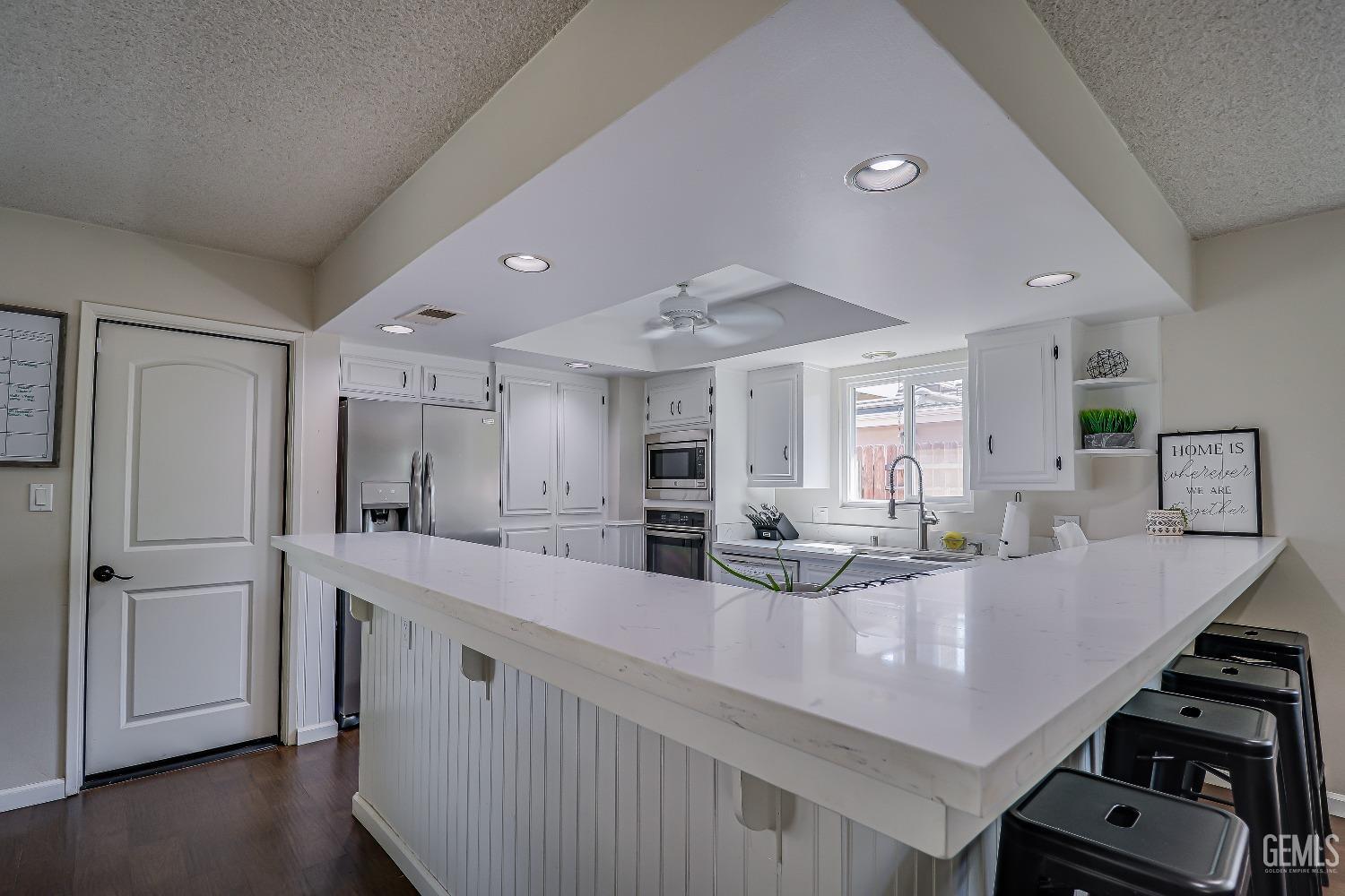 Undisclosed Address Bakersfield, CA 93308 - Photo 13 of 38 a kitchen with stainless steel appliances granite countertop a sink counter space and cabinets