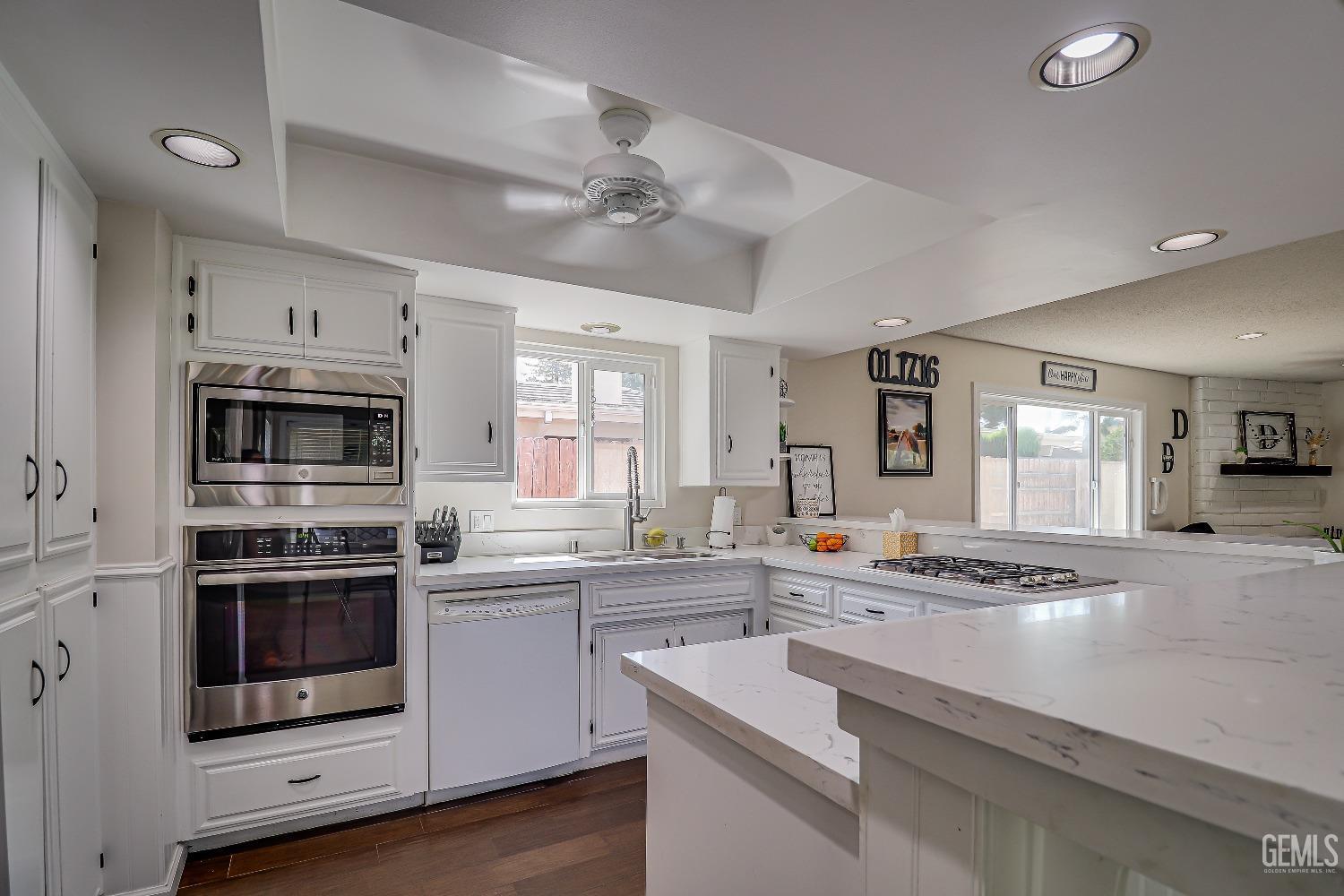 Undisclosed Address Bakersfield, CA 93308 - Photo 15 of 38 a kitchen with stainless steel appliances white cabinets and stove top oven