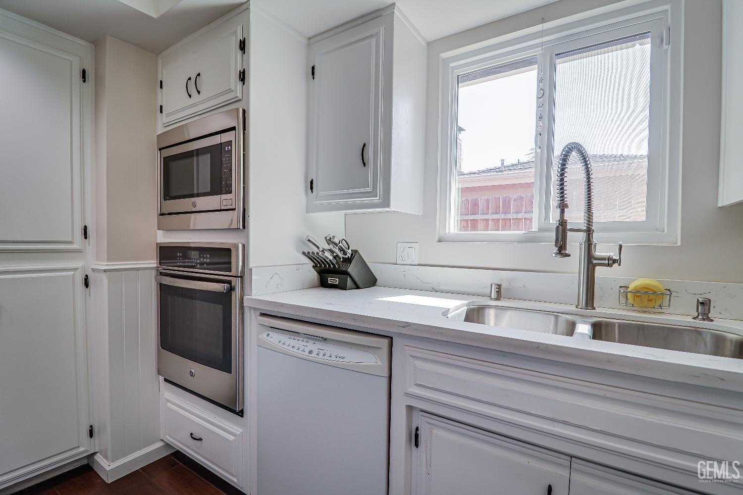 Undisclosed Address Bakersfield, CA 93308 - Photo 18 of 38 a kitchen with stainless steel appliances a stove sink and microwave