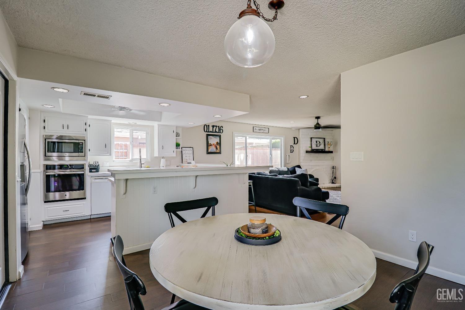 Undisclosed Address Bakersfield, CA 93308 - Photo 19 of 38 a kitchen with dining table and chairs