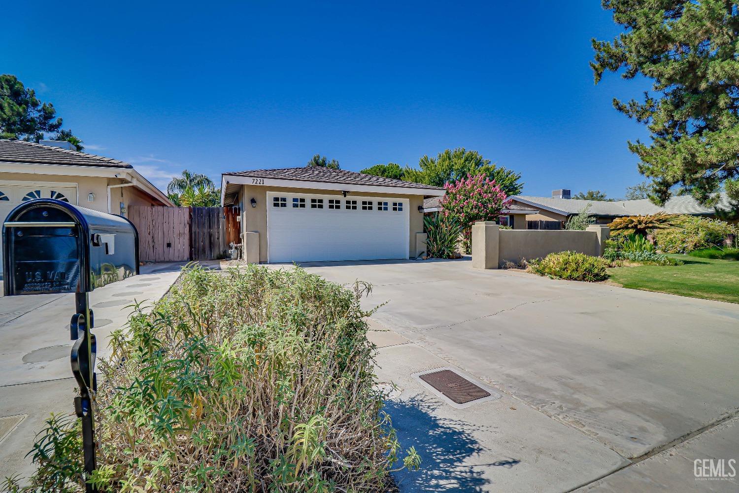 Undisclosed Address Bakersfield, CA 93308 - Photo 2 of 38 a view of a house with a yard and potted plants