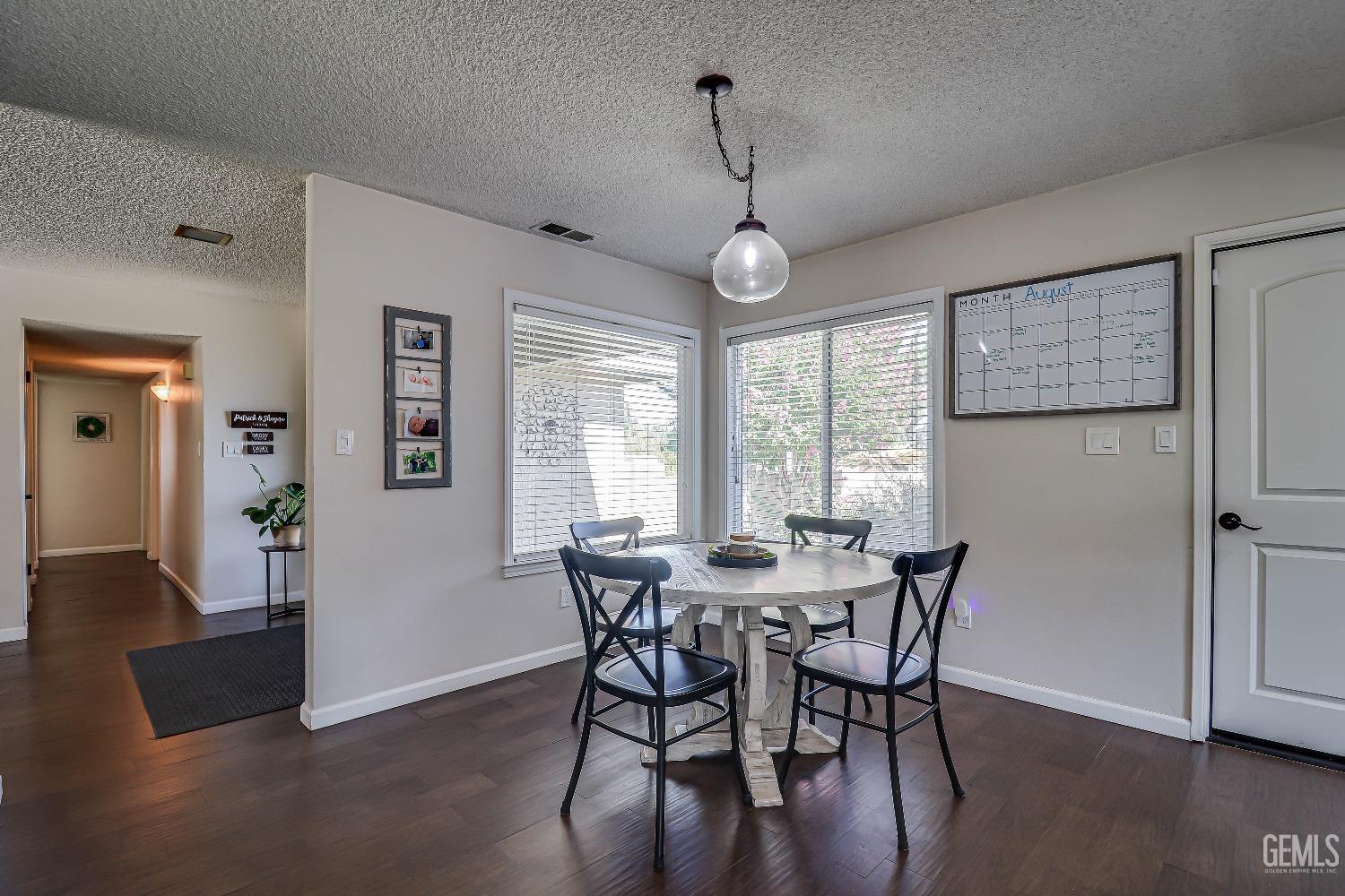 Undisclosed Address Bakersfield, CA 93308 - Photo 21 of 38 a view of a dining room with furniture window and wooden floor