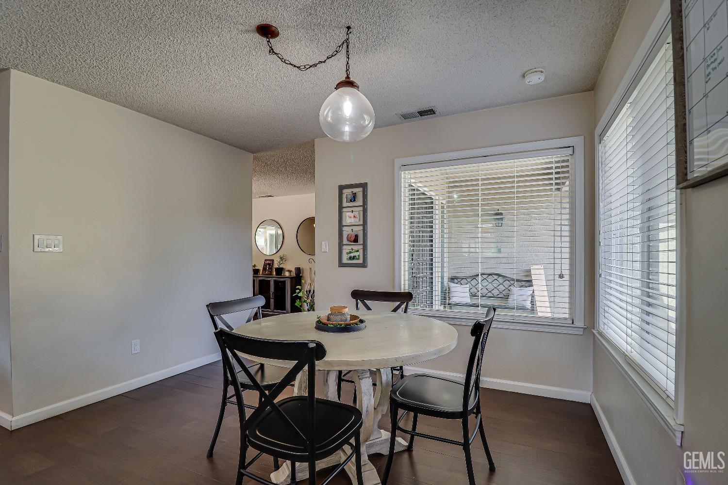 Undisclosed Address Bakersfield, CA 93308 - Photo 22 of 38 a view of a dining room with furniture window and wooden floor