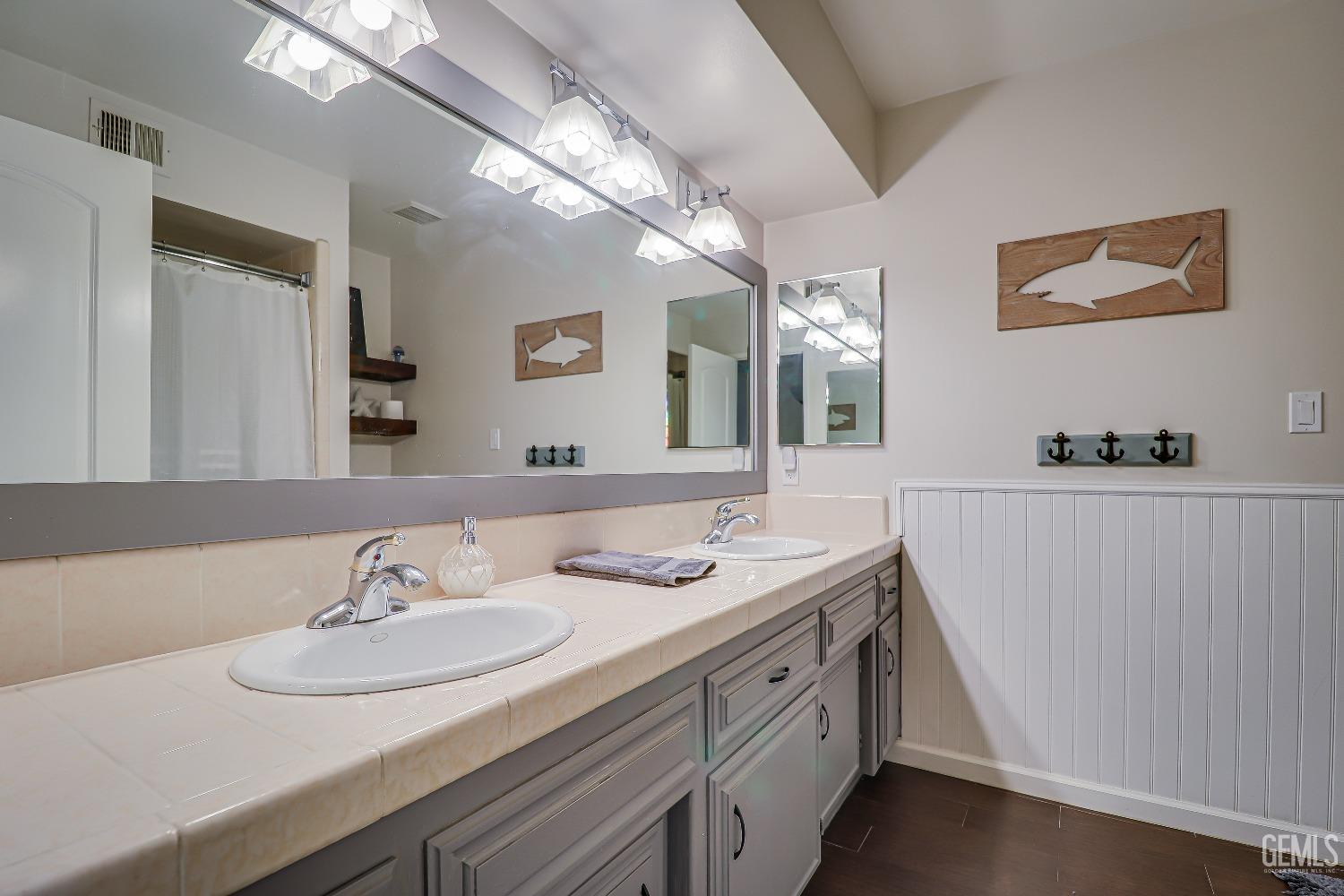 Undisclosed Address Bakersfield, CA 93308 - Photo 24 of 38 a bathroom with a sink double vanity and a mirror
