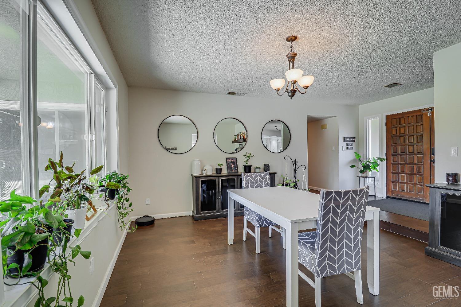 Undisclosed Address Bakersfield, CA 93308 - Photo 7 of 38 a living room with furniture a large window and a clock
