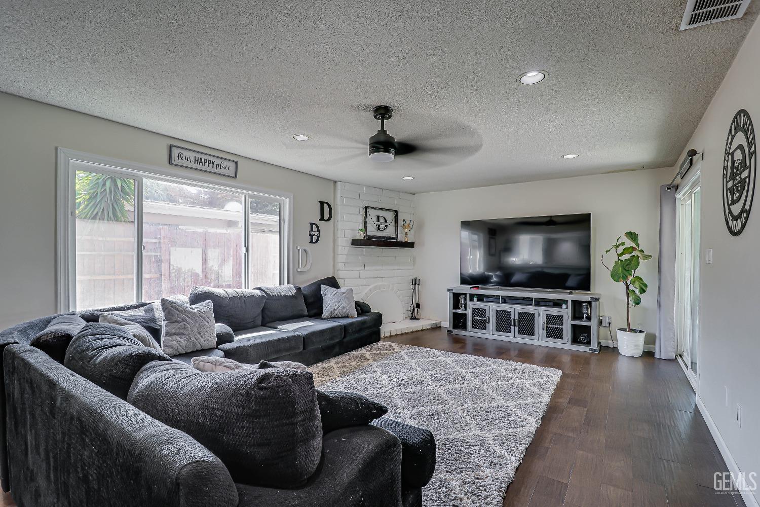 Undisclosed Address Bakersfield, CA 93308 - Photo 9 of 38 a living room with furniture and a flat screen tv