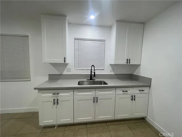 a kitchen with white cabinets