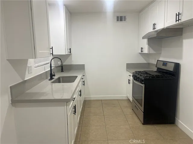 a kitchen that has a sink and a stove