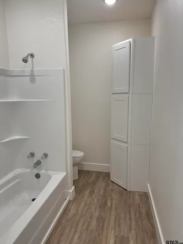 a bathroom with a bathtub and toilet