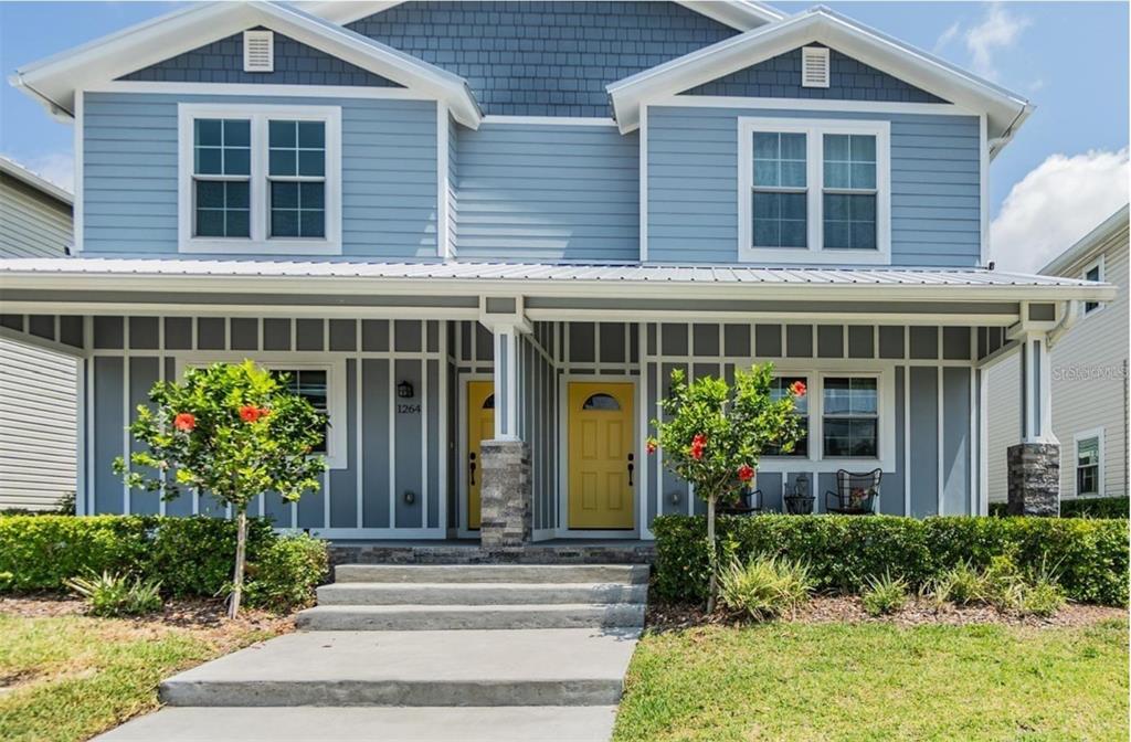 1264 Pierce Street Clearwater, FL 33756 - Photo 1 of 16 front view of a brick house with a yard and plants