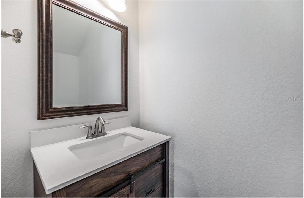 1264 Pierce Street Clearwater, FL 33756 - Photo 12 of 16 a bathroom with a sink and a mirror