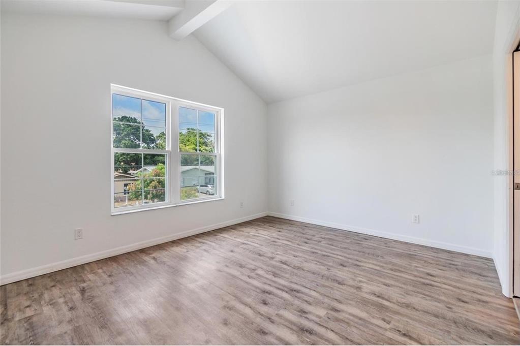 1264 Pierce Street Clearwater, FL 33756 - Photo 6 of 16 an empty room with wooden floor and windows