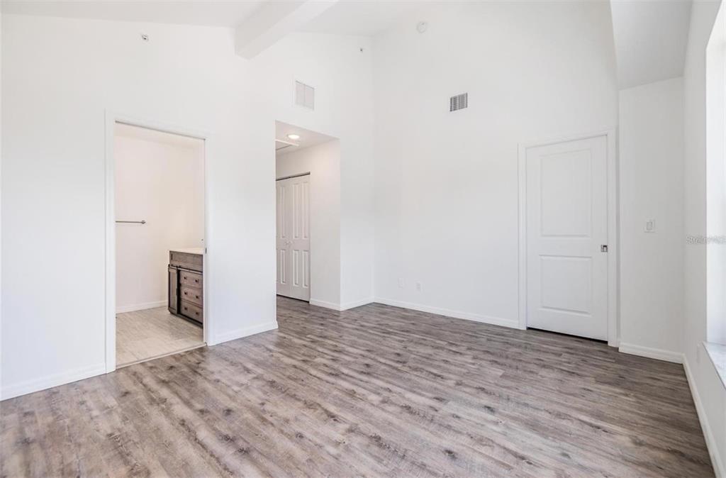 1264 Pierce Street Clearwater, FL 33756 - Photo 7 of 16 a view of an empty room with wooden floor and a bathroom