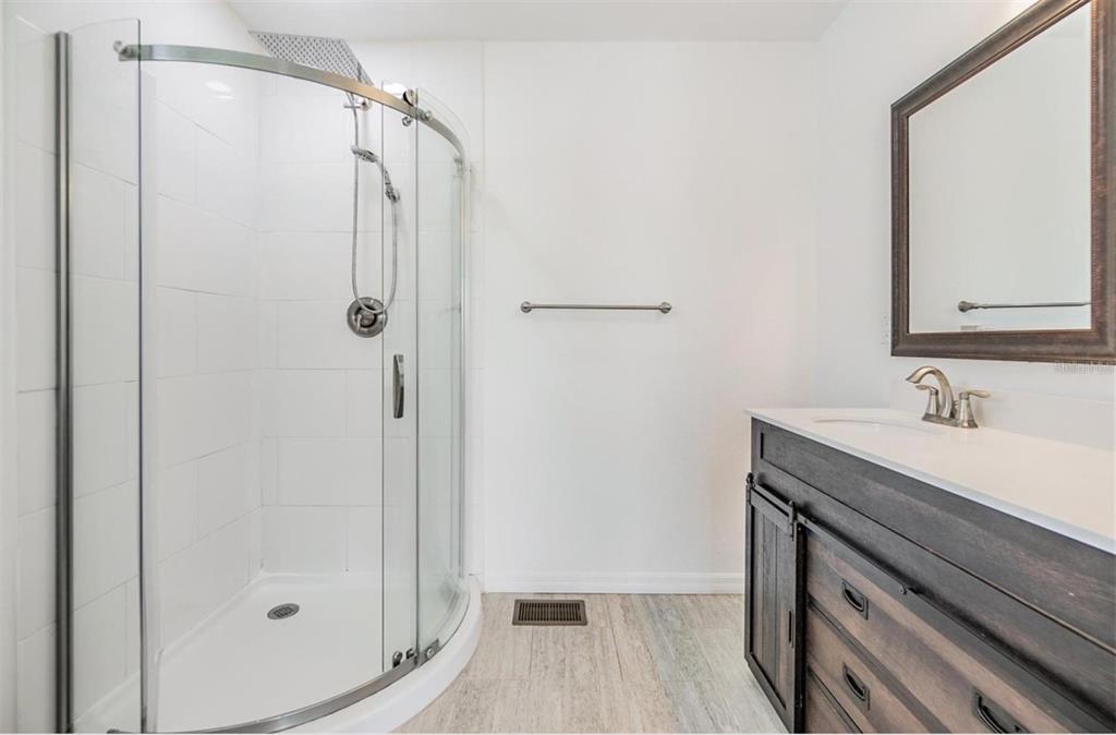 1264 Pierce Street Clearwater, FL 33756 - Photo 8 of 16 a bathroom with a shower sink and mirror