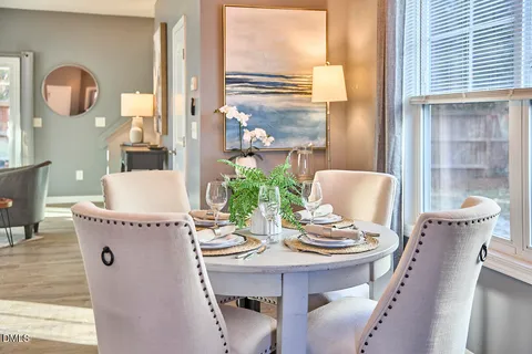 a view of a dining room with furniture and a window