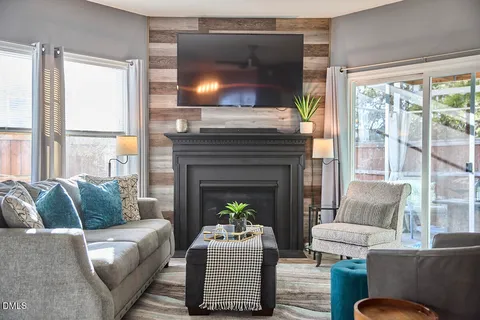 a living room with furniture and a fireplace