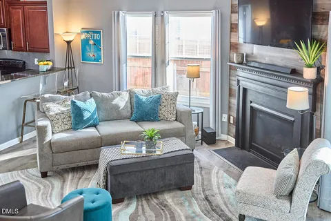 a living room with furniture and a fireplace