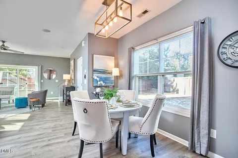 a view of a dining room with furniture window and wooden floor