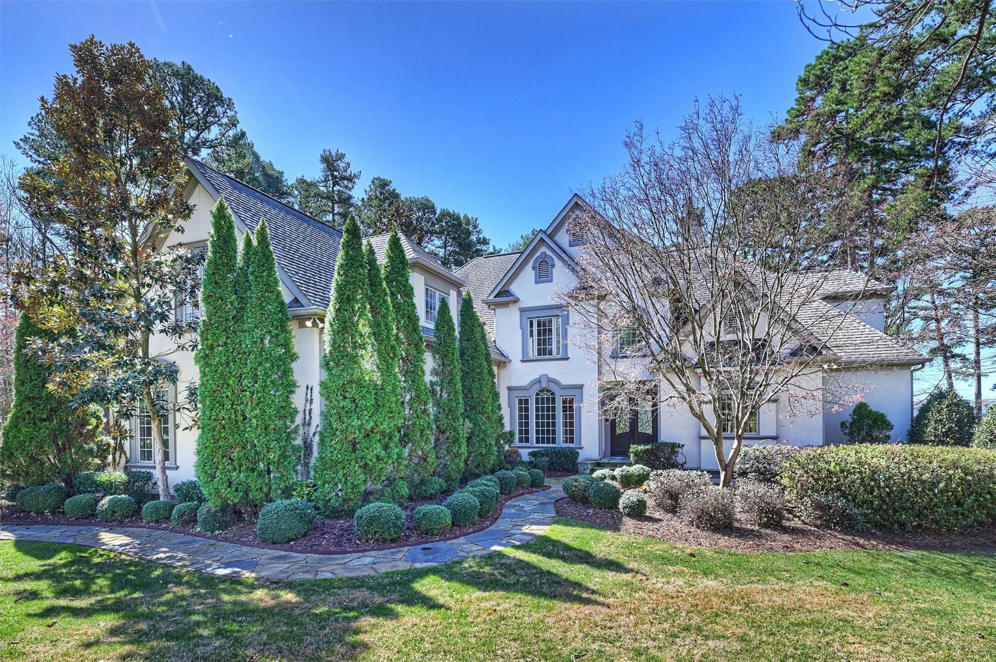 a view of a house with a yard and plants