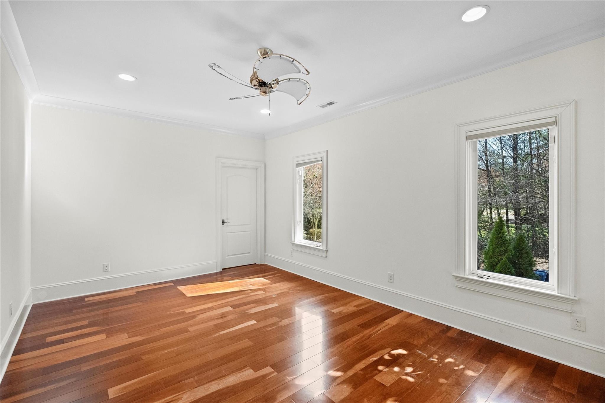 16824 Flying Jib Road Cornelius, NC 28031 - Photo 29 of 48 an empty room with wooden floor fan and windows
