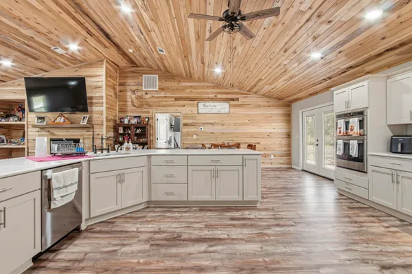 a kitchen with a sink cabinets and window