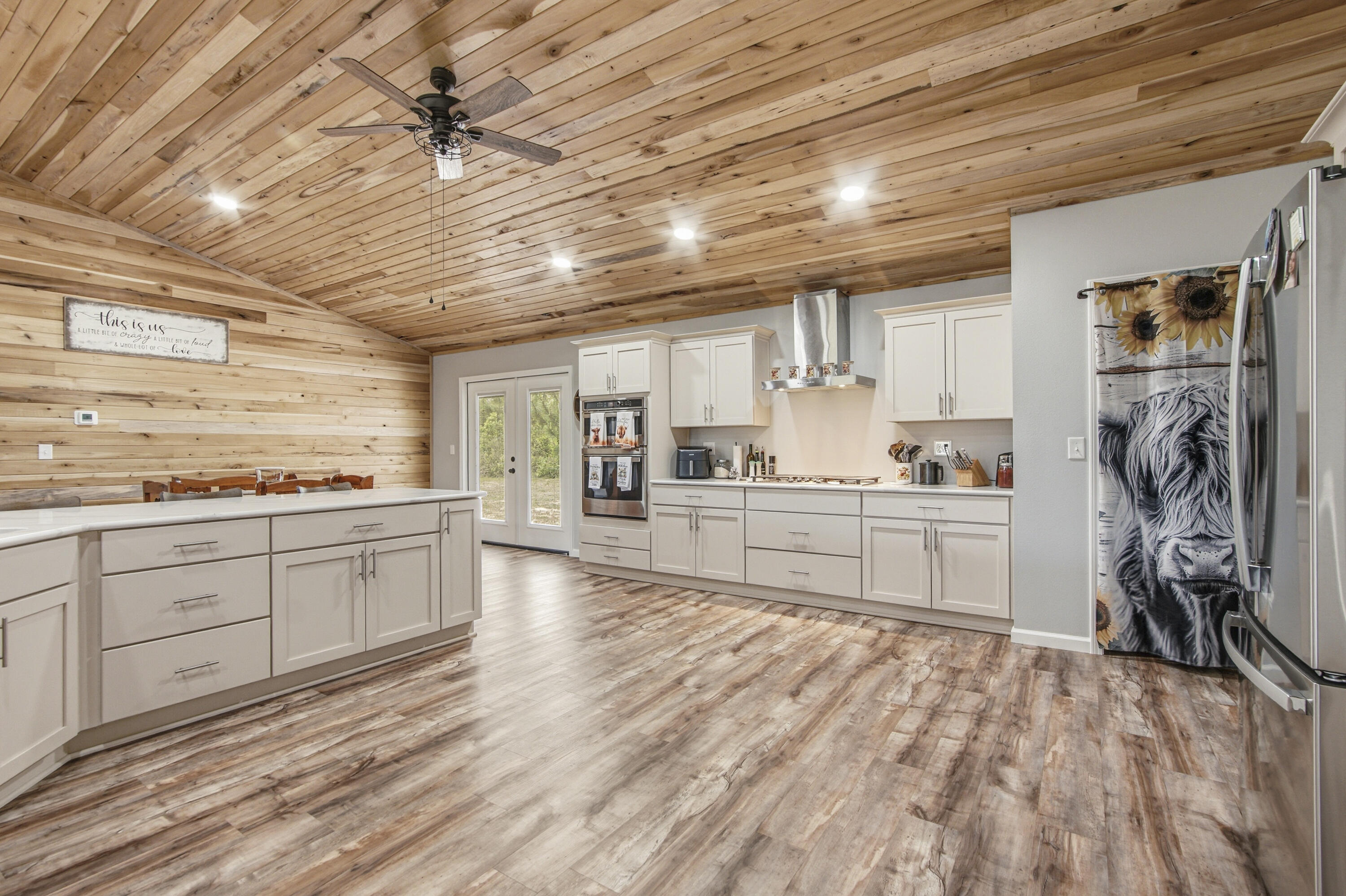 7514 Laird Road Florala, AL 36442 - Photo 12 of 48 a kitchen with a refrigerator and white cabinets